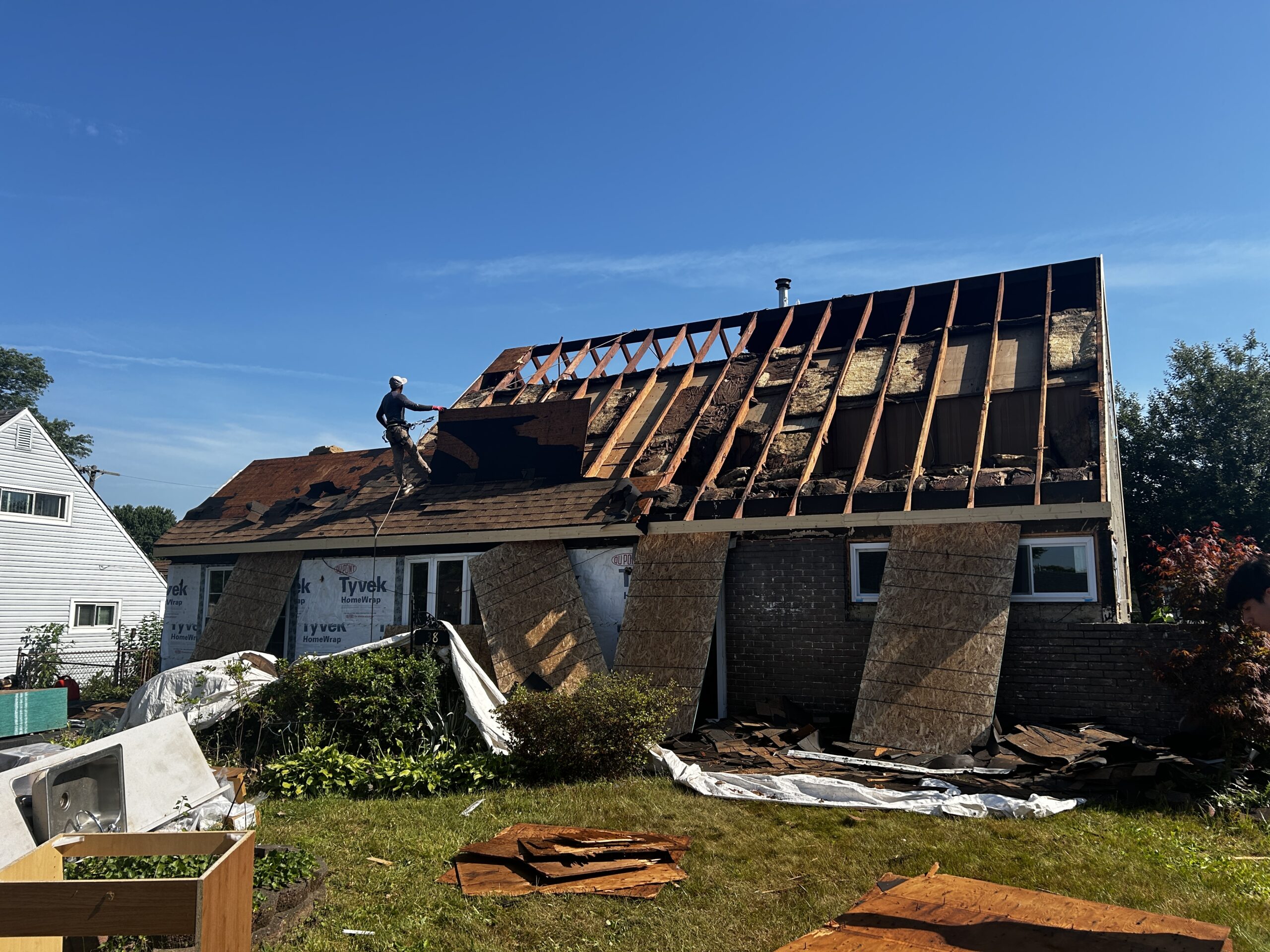 Front elevation with new siding, windows, and entry detail.